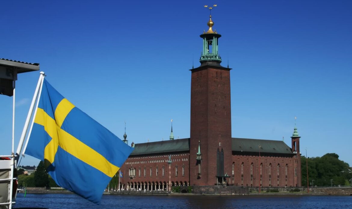 Svenska flaggan framför Stockholms stadshus – symbol för officiella notarietjänster och apostille i Sverige.